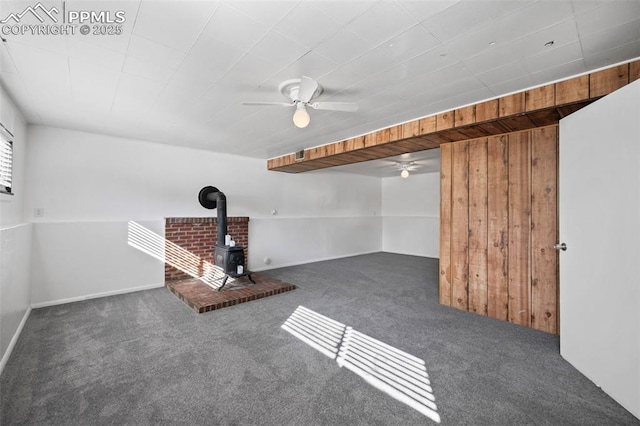 1540 Shasta Dr, Colorado Springs, CO 80910 - finished basement featuring a wood stove, carpet flooring, and a ceiling fan