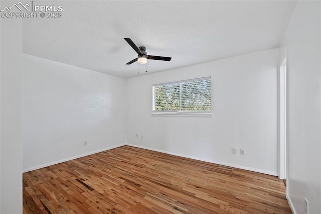 1540 Shasta Dr, Colorado Springs, CO 80910 - empty room with a ceiling fan, wood finished floors, baseboards, and a textured ceiling