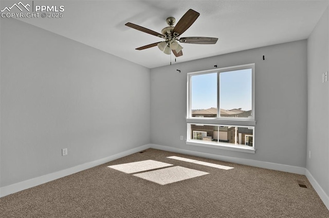 spare room featuring ceiling fan, baseboards, and carpet floors