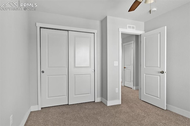 unfurnished bedroom featuring a closet, visible vents, baseboards, and carpet floors