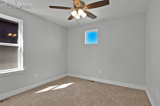 empty room with ceiling fan, baseboards, visible vents, and carpet floors