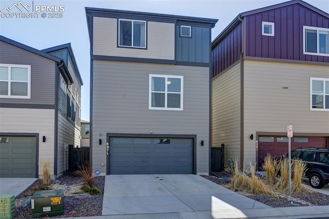 view of front of house with an attached garage, board and batten siding, and concrete driveway