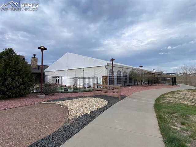 view of home's community featuring fence