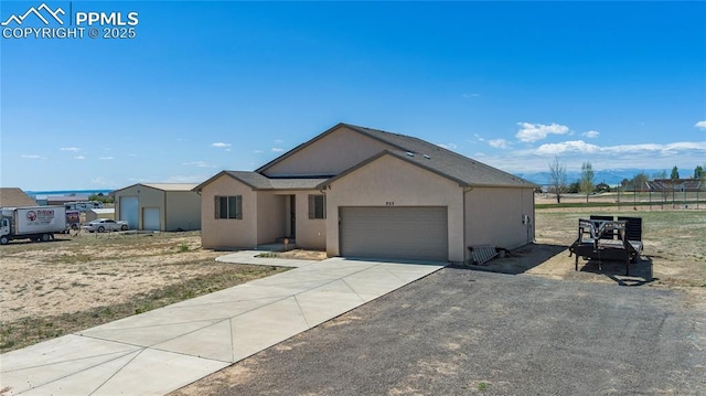 955 S Los Charros Dr, Pueblo West, CO 81007 - view of front of home with driveway, stucco siding, and an attached garage
