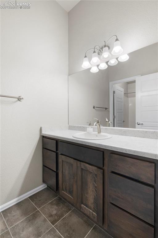 955 S Los Charros Dr, Pueblo West, CO 81007 - bathroom featuring tile patterned floors, vanity, baseboards, and an inviting chandelier