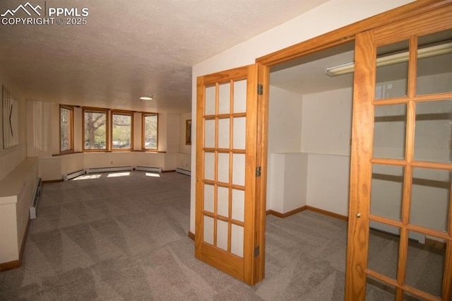 2324 W Willamette Ave, Colorado Springs, CO 80904 - hall with carpet flooring, a textured ceiling, baseboards, and a baseboard radiator