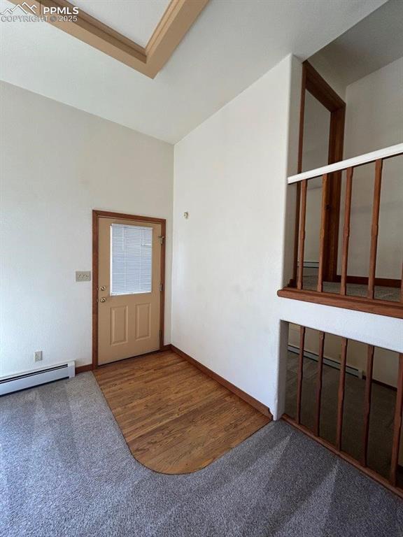 2324 W Willamette Ave, Colorado Springs, CO 80904 - carpeted foyer with a baseboard radiator, a baseboard heating unit, baseboards, and wood finished floors