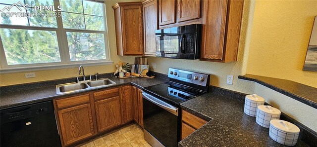 kitchen featuring a sink, black appliances, and brown cabinets