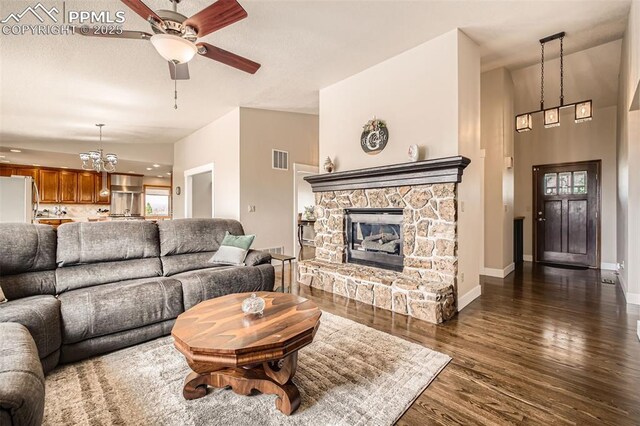 440 Scrub Oak Cir, Monument, CO 80132 - living area with a ceiling fan, a chandelier, dark wood-style floors, a fireplace, and baseboards