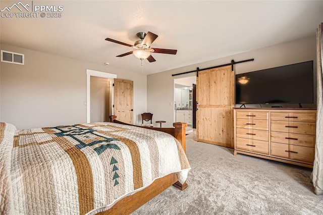 440 Scrub Oak Cir, Monument, CO 80132 - bedroom featuring light colored carpet, a barn door, ceiling fan, and ensuite bathroom