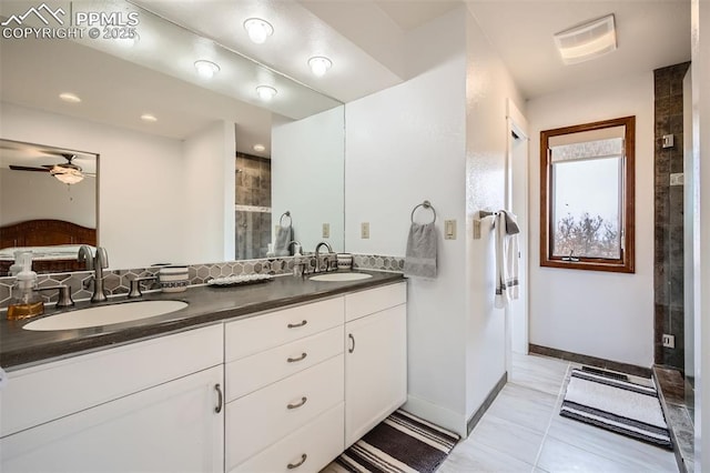 440 Scrub Oak Cir, Monument, CO 80132 - bathroom featuring ceiling fan, tiled shower, double vanity, and baseboards