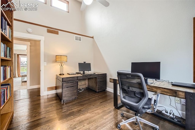 440 Scrub Oak Cir, Monument, CO 80132 - home office with a ceiling fan, plenty of natural light, a high ceiling, dark wood finished floors, and baseboards