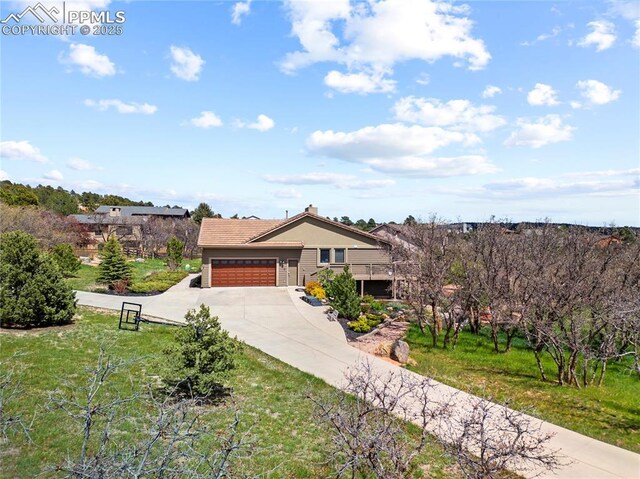 440 Scrub Oak Cir, Monument, CO 80132 - view of front of property featuring a garage, concrete driveway, and a front lawn