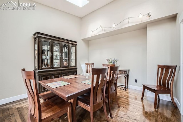 440 Scrub Oak Cir, Monument, CO 80132 - dining room featuring wood finished floors, baseboards, and a skylight