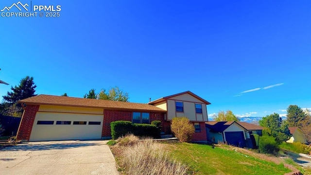 5125 Thistle Ct, Colorado Springs, CO 80917 - split level home featuring brick siding, an attached garage, and concrete driveway