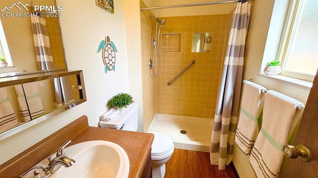 5125 Thistle Ct, Colorado Springs, CO 80917 - full bath featuring tiled shower, toilet, vanity, and wood finished floors