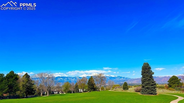5125 Thistle Ct, Colorado Springs, CO 80917 - surrounding community featuring a mountain view and a lawn
