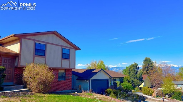 5125 Thistle Ct, Colorado Springs, CO 80917 - view of front of property featuring brick siding, a garage, and stairs