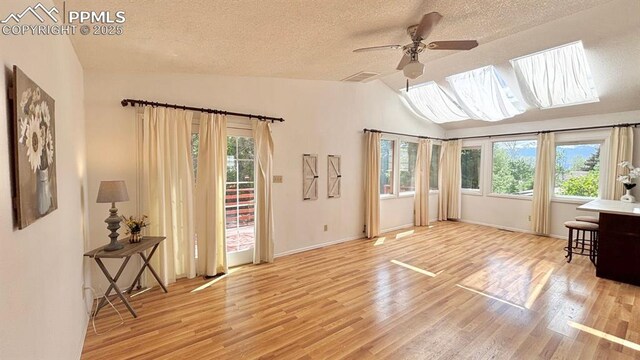 5125 Thistle Ct, Colorado Springs, CO 80917 - living area featuring wood finished floors, ceiling fan, a textured ceiling, lofted ceiling, and baseboards