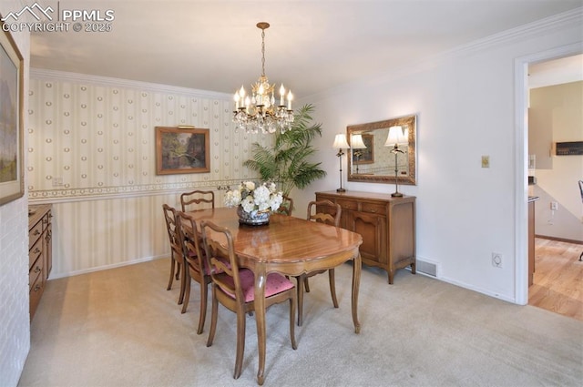 dining space featuring crown molding, light colored carpet, baseboards, and a chandelier