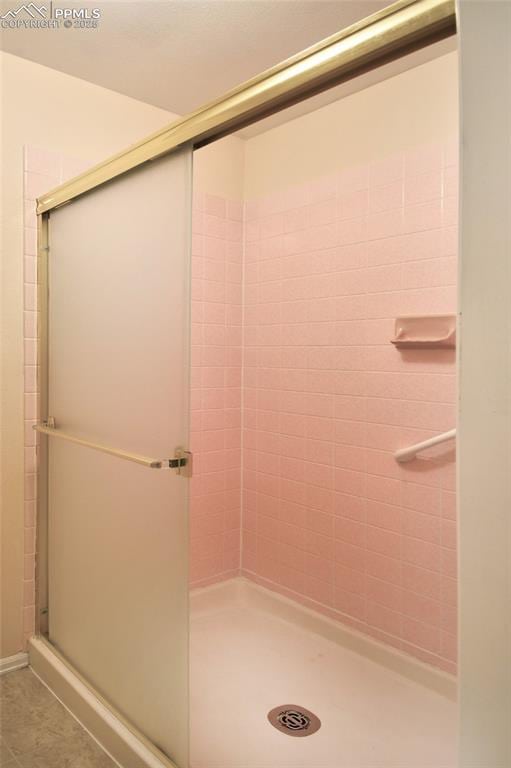 full bath featuring a shower stall