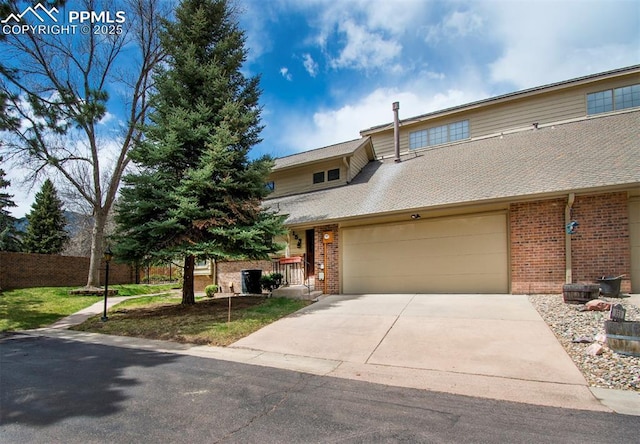 view of front of property with a garage, concrete driveway, and brick siding