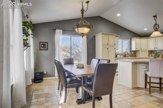 dining space featuring baseboards, lofted ceiling, and recessed lighting