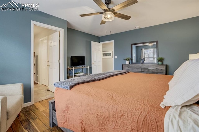 bedroom with baseboards, wood finished floors, and ceiling fan