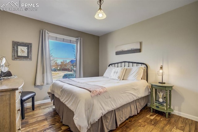 bedroom featuring wood finished floors and baseboards