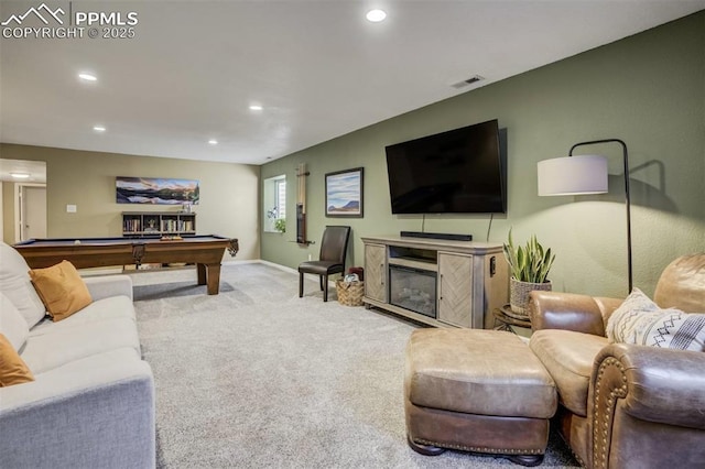 carpeted living room featuring visible vents, baseboards, a glass covered fireplace, recessed lighting, and pool table
