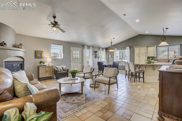 living room featuring light tile patterned flooring, a glass covered fireplace, ceiling fan, lofted ceiling, and recessed lighting