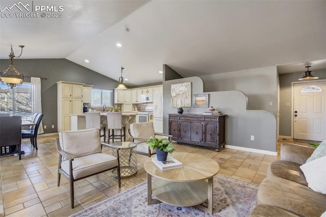 living room with lofted ceiling, baseboards, and recessed lighting