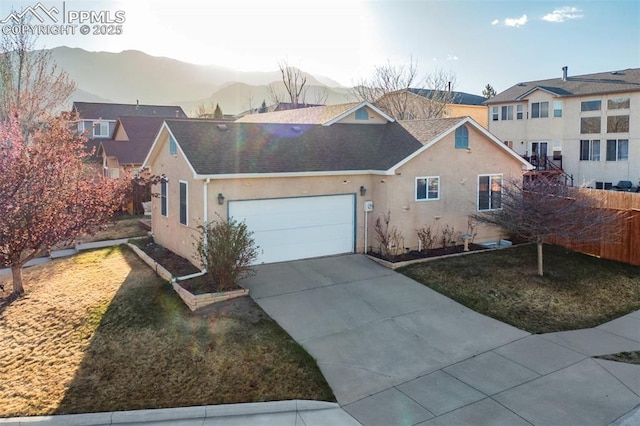 view of front of property featuring fence, concrete driveway, stucco siding, roof with shingles, and a garage