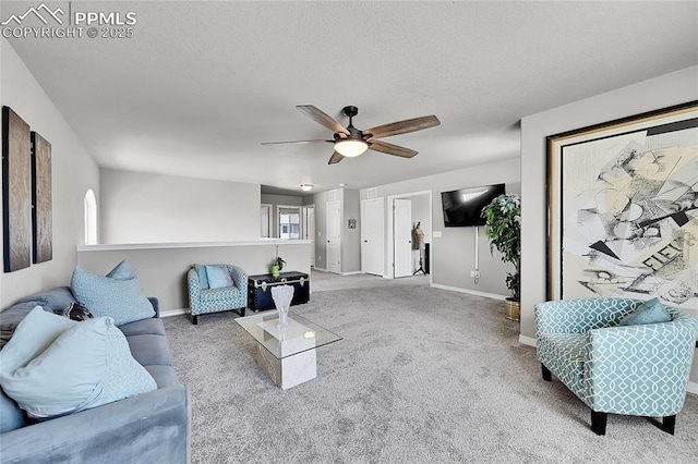 living room featuring carpet floors, baseboards, and ceiling fan