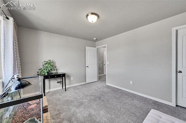 bedroom featuring carpet and baseboards