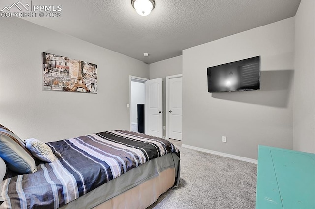 bedroom with baseboards, carpet floors, and a textured ceiling