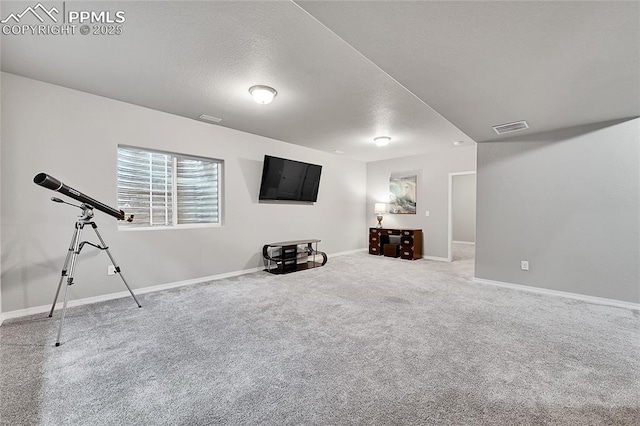 interior space with baseboards, visible vents, carpet, and a textured ceiling