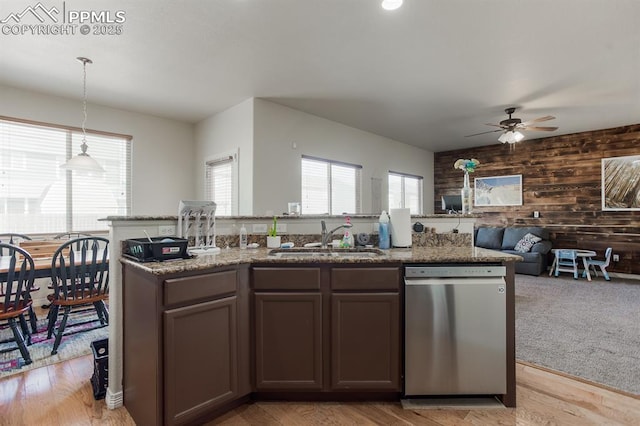 6117 Hayfield Pl, Colorado Springs, CO 80925 - kitchen featuring open floor plan, wooden walls, a ceiling fan, dishwasher, and a sink