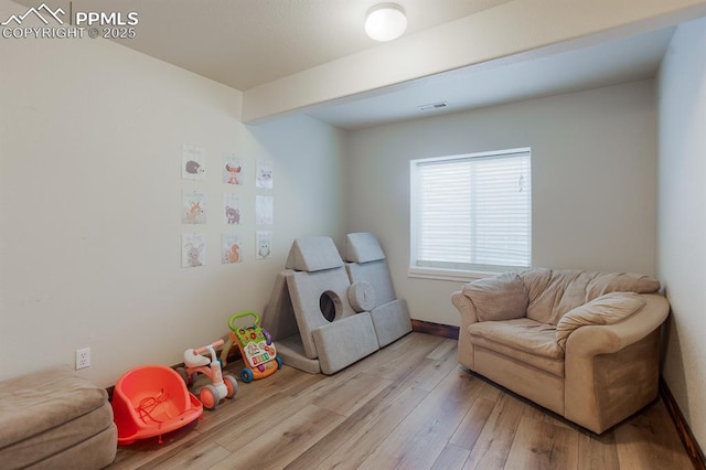 6117 Hayfield Pl, Colorado Springs, CO 80925 - playroom with wood finished floors, baseboards, and visible vents