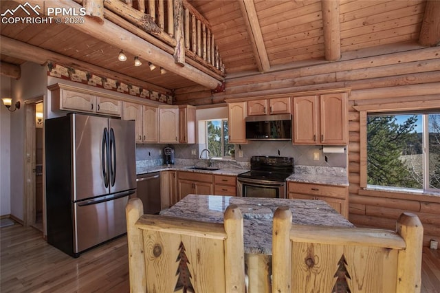 876 Obsidian Dr, Florissant, CO 80816 - kitchen with log walls, light stone countertops, wood ceiling, a sink, and stainless steel appliances