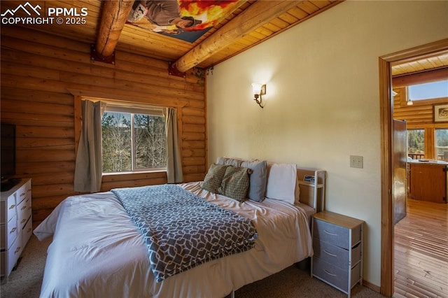 876 Obsidian Dr, Florissant, CO 80816 - bedroom with log walls, multiple windows, and beam ceiling