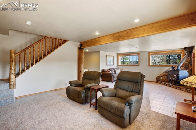 876 Obsidian Dr, Florissant, CO 80816 - tiled living area with recessed lighting, a wood stove, stairs, and carpet floors