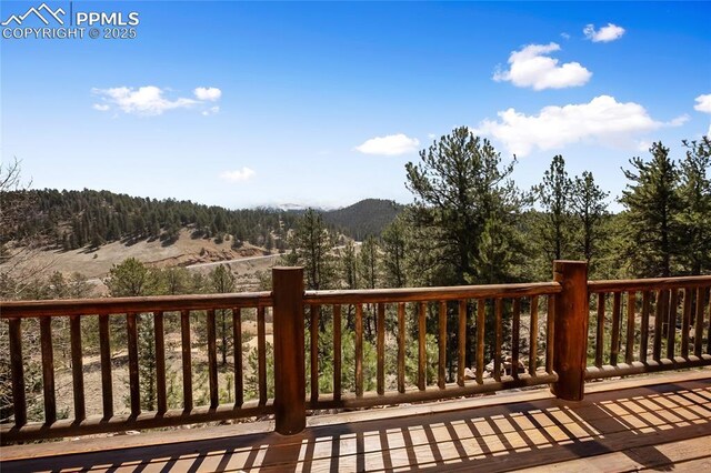 876 Obsidian Dr, Florissant, CO 80816 - wooden deck featuring a mountain view and a wooded view
