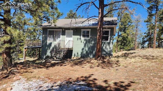 616 Moffat Dr, Cripple Creek, CO 80813 - back of property with a shingled roof and entry steps