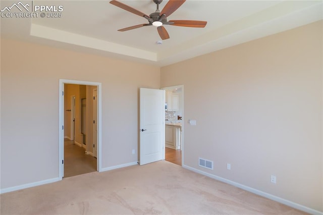 1474 Promontory Bluff Vw, Colorado Springs, CO 80921 - unfurnished bedroom with light colored carpet, baseboards, a raised ceiling, and a ceiling fan
