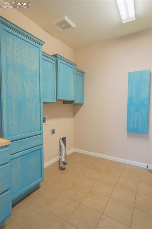 1474 Promontory Bluff Vw, Colorado Springs, CO 80921 - laundry area featuring hookup for an electric dryer, baseboards, cabinet space, and light tile patterned floors