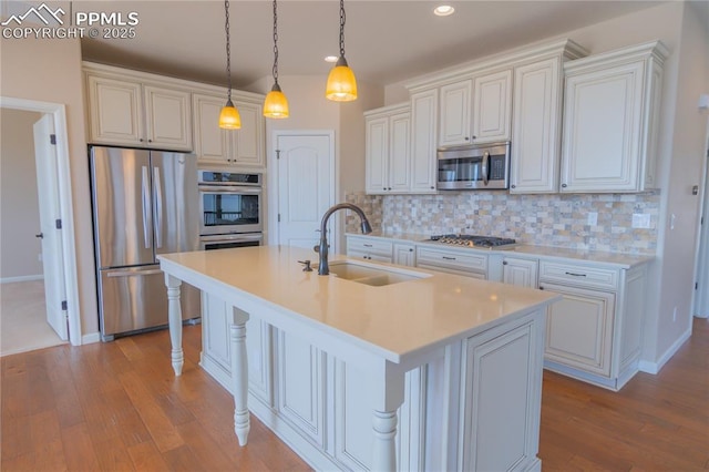 1474 Promontory Bluff Vw, Colorado Springs, CO 80921 - kitchen with appliances with stainless steel finishes, a sink, wood finished floors, backsplash, and recessed lighting