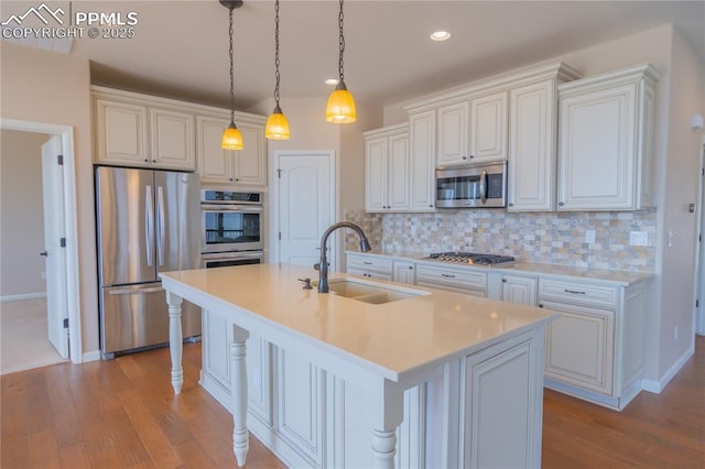 1474 Promontory Bluff Vw, Colorado Springs, CO 80921 - kitchen with appliances with stainless steel finishes, a sink, light wood-style flooring, backsplash, and recessed lighting