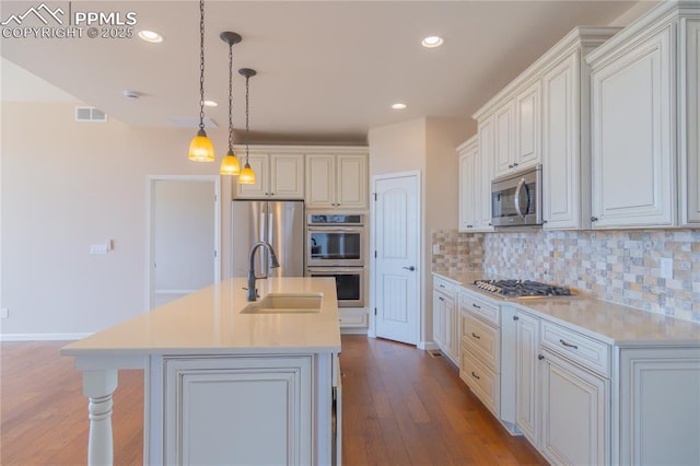 1474 Promontory Bluff Vw, Colorado Springs, CO 80921 - kitchen featuring a sink, stainless steel appliances, wood finished floors, light countertops, and recessed lighting
