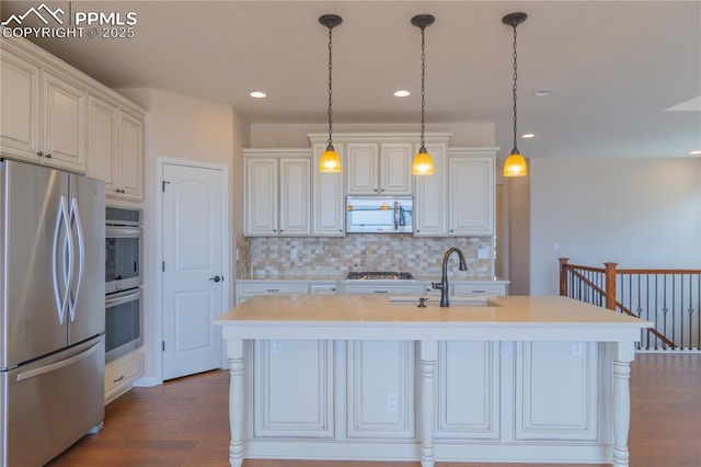 1474 Promontory Bluff Vw, Colorado Springs, CO 80921 - kitchen with stainless steel appliances, a sink, backsplash, dark wood-style floors, and light countertops